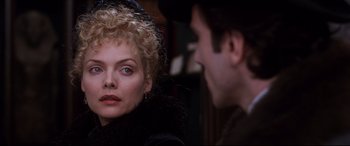 Movie still from “The Age of Innocence” (1993), directed by Martin Scorsese – A man and a woman are looking at each other; Close Up shot, Over the shoulder angle