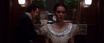 Movie still from “The Age of Innocence” (1993), directed by Martin Scorsese – A woman in a white dress and a man in a black suit; Close Up shot, Over the shoulder angle