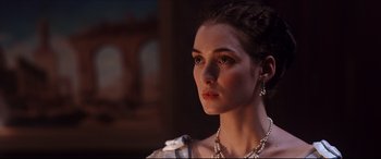 Movie still from “The Age of Innocence” (1993), directed by Martin Scorsese – A beautiful young woman wearing a necklace and earrings; Close Up shot, Over the shoulder angle