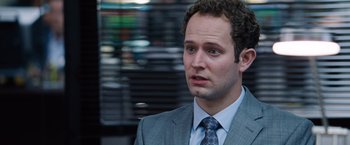 Movie still from “The Big Short” (2015), directed by Adam McKay – A man in a gray suit and a blue tie; Close Up shot, Over the shoulder angle