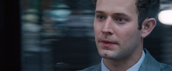 Movie still from “The Big Short” (2015), directed by Adam McKay – A person wearing a suit and tie; Close Up shot, Over the shoulder angle