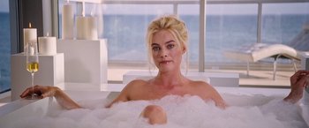 Movie still from “The Big Short” (2015), directed by Adam McKay – A woman sitting in a bath tub in a room; Medium shot, High angle