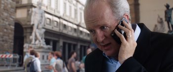 Movie still from “The Big Short” (2015), directed by Adam McKay – An older man talking on a cell phone; Close Up shot, Over the shoulder angle