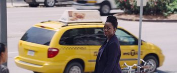 Movie still from “The Big Short” (2015), directed by Adam McKay – A woman standing in front of a yellow taxi cab; Medium shot, Over the shoulder angle