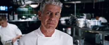 Movie still from “The Big Short” (2015), directed by Adam McKay – A person wearing a chef's outfit; Close Up shot, Over the shoulder angle