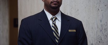 Movie still from “The Big Short” (2015), directed by Adam McKay – A person wearing a suit and tie; Close Up shot, High angle