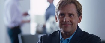 Movie still from “The Big Short” (2015), directed by Adam McKay – A person wearing a suit and tie; Close Up shot, Over the shoulder angle