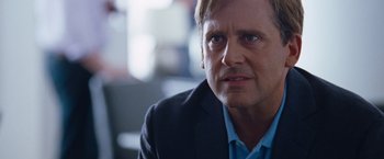 Movie still from “The Big Short” (2015), directed by Adam McKay – A person wearing a suit and tie; Close Up shot, Over the shoulder angle