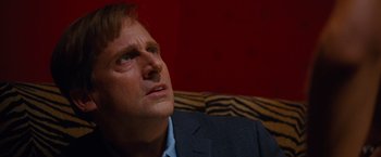 Movie still from “The Big Short” (2015), directed by Adam McKay – A person sitting on a couch; Close Up shot, High angle