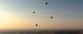 Movie still from “The Big Short” (2015), directed by Adam McKay – A group of hot air balloons flying in the sky; Extreme Wide shot, Low angle