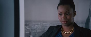 Movie still from “The Big Short” (2015), directed by Adam McKay – A person wearing a suit and a necklace; Close Up shot, Over the shoulder angle