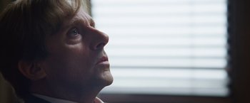 Movie still from “The Big Short” (2015), directed by Adam McKay – An older man looking up into the sky; Close Up shot, Low angle