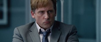 Movie still from “The Big Short” (2015), directed by Adam McKay – A person wearing a suit and tie; Close Up shot, Low angle