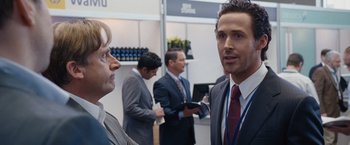 Movie still from “The Big Short” (2015), directed by Adam McKay – Two men in suits and ties standing next to each other; Close Up shot, Over the shoulder angle