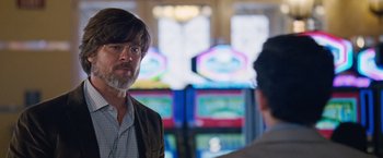 Movie still from “The Big Short” (2015), directed by Adam McKay – A man with a goatee talking to another man; Close Up shot, Over the shoulder angle
