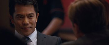 Movie still from “The Big Short” (2015), directed by Adam McKay – A person wearing a suit and tie; Close Up shot, Over the shoulder angle