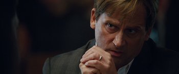 Movie still from “The Big Short” (2015), directed by Adam McKay – A person wearing a suit and a ring; Close Up shot, Low angle