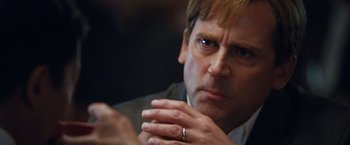 Movie still from “The Big Short” (2015), directed by Adam McKay – A person wearing a ring; Close Up shot, Over the shoulder angle