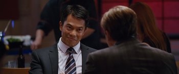 Movie still from “The Big Short” (2015), directed by Adam McKay – A man wearing a suit and tie talking to another man wearing a suit and tie; Close Up shot, Over the shoulder angle