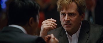 Movie still from “The Big Short” (2015), directed by Adam McKay – A man in a business suit talking to another man in a business suit; Close Up shot, Over the shoulder angle