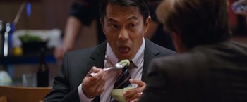Movie still from “The Big Short” (2015), directed by Adam McKay – A person holding a spoon with food in it; Close Up shot, Over the shoulder angle