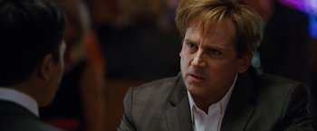 Movie still from “The Big Short” (2015), directed by Adam McKay – A person wearing a suit and tie; Close Up shot, Over the shoulder angle