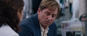 Movie still from “The Big Short” (2015), directed by Adam McKay – A person wearing a suit and tie; Close Up shot, Over the shoulder angle