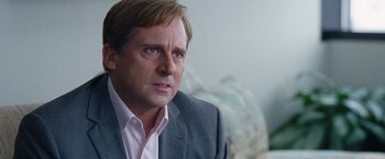 Movie still from “The Big Short” (2015), directed by Adam McKay – A person wearing a suit and tie; Close Up shot, Over the shoulder angle