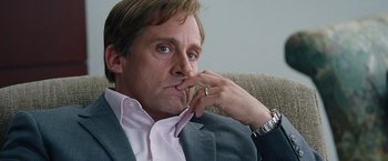 Movie still from “The Big Short” (2015), directed by Adam McKay – A person sitting on a couch with his hand to his face; Close Up shot, Low angle