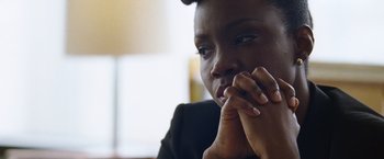 Movie still from “The Big Short” (2015), directed by Adam McKay – A person with their hand on their chin; Close Up shot, Over the shoulder angle