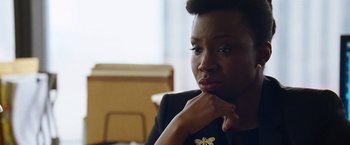 Movie still from “The Big Short” (2015), directed by Adam McKay – A person with her hand on her chin; Close Up shot, Over the shoulder angle