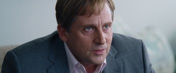Movie still from “The Big Short” (2015), directed by Adam McKay – A person wearing a suit and tie; Close Up shot, Over the shoulder angle
