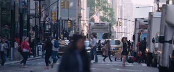 Movie still from “The Big Short” (2015), directed by Adam McKay – A busy city street with a bus and cars on the road; Extreme Wide shot, Low angle