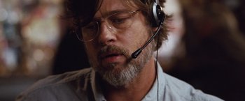 Movie still from “The Big Short” (2015), directed by Adam McKay – A person wearing a headset; Close Up shot, Low angle