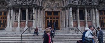 Movie still from “The Big Short” (2015), directed by Adam McKay – A group of people sitting on the steps of a building; Extreme Wide shot, High angle