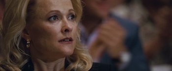 Movie still from “The Big Short” (2015), directed by Adam McKay – A person with blonde hair; Close Up shot, Over the shoulder angle