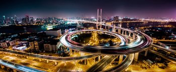 Movie still from “The Big Short” (2015), directed by Adam McKay – An aerial view of a city at night with lights; Extreme Wide shot, High angle