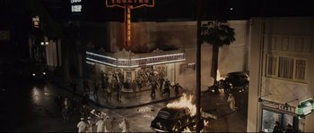 Movie still from “The Black Dahlia” (2006), directed by Brian De Palma – A scene of a movie theater with a fire coming out of the building; Extreme Wide shot, High angle