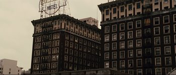 Movie still from “The Black Dahlia” (2006), directed by Brian De Palma – A group of old buildings that are in the city; Extreme Wide shot, Low angle