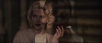 Movie still from “The Black Dahlia” (2006), directed by Brian De Palma – A woman smoking a cigarette in front of a mirror; Close Up shot, Low angle