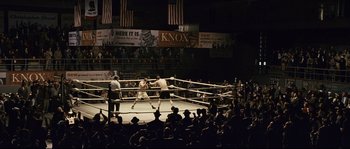 Movie still from “The Black Dahlia” (2006), directed by Brian De Palma – A boxing match in progress in an arena with spectators watching; Extreme Wide shot, High angle