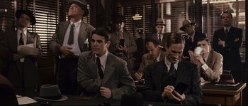 Movie still from “The Black Dahlia” (2006), directed by Brian De Palma – A group of men in suits and ties sitting at a table; Medium shot, Over the shoulder angle