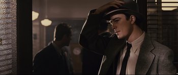 Movie still from “The Black Dahlia” (2006), directed by Brian De Palma – A man in a suit and a hat; Close Up shot, Low angle