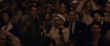 Movie still from “The Black Dahlia” (2006), directed by Brian De Palma – A group of people are gathered together in a room; Medium shot, High angle