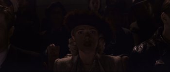 Movie still from “The Black Dahlia” (2006), directed by Brian De Palma – A woman in a hat is in a dark room; Close Up shot, Low angle