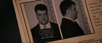 Movie still from “The Black Dahlia” (2006), directed by Brian De Palma – A black - and - white photo of a man in a suit and tie; Close Up shot, Low angle