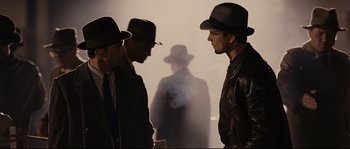 Movie still from “The Black Dahlia” (2006), directed by Brian De Palma – A group of men standing next to each other in front of smoke; Medium shot, Over the shoulder angle