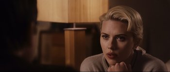 Movie still from “The Black Dahlia” (2006), directed by Brian De Palma – A person sitting in a room near a lamp; Close Up shot, Over the shoulder angle