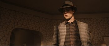 Movie still from “The Black Dahlia” (2006), directed by Brian De Palma – A man wearing a hat and a suit; Medium shot, Low angle