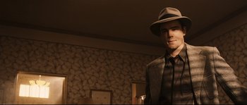 Movie still from “The Black Dahlia” (2006), directed by Brian De Palma – A man wearing a hat and a suit; Medium shot, Low angle